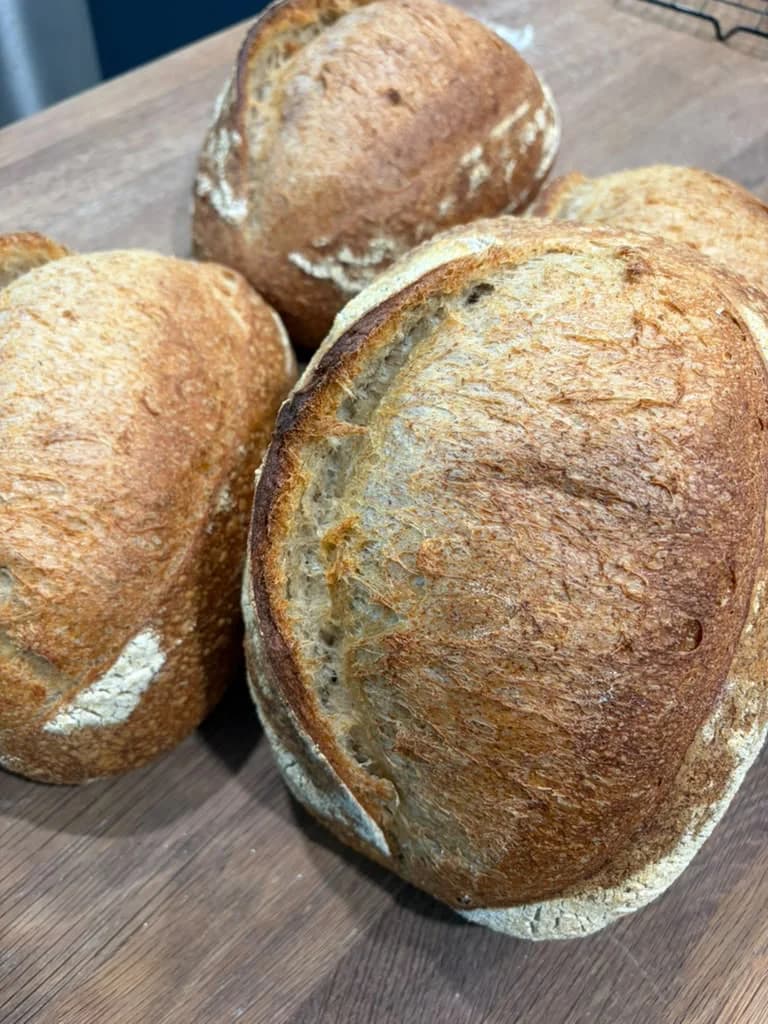 Rustic sourdough loaves cooling after baking