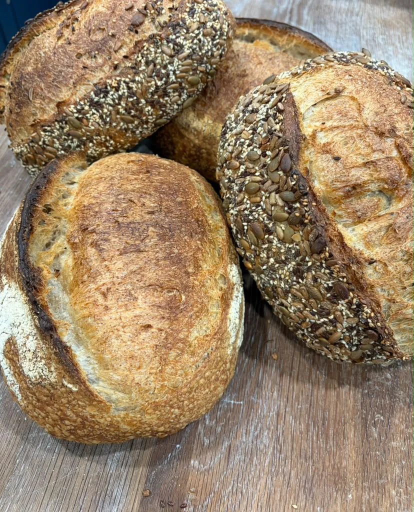 Seeded sourdough loaves covered with pumpkin, sunflower, and sesame seeds
